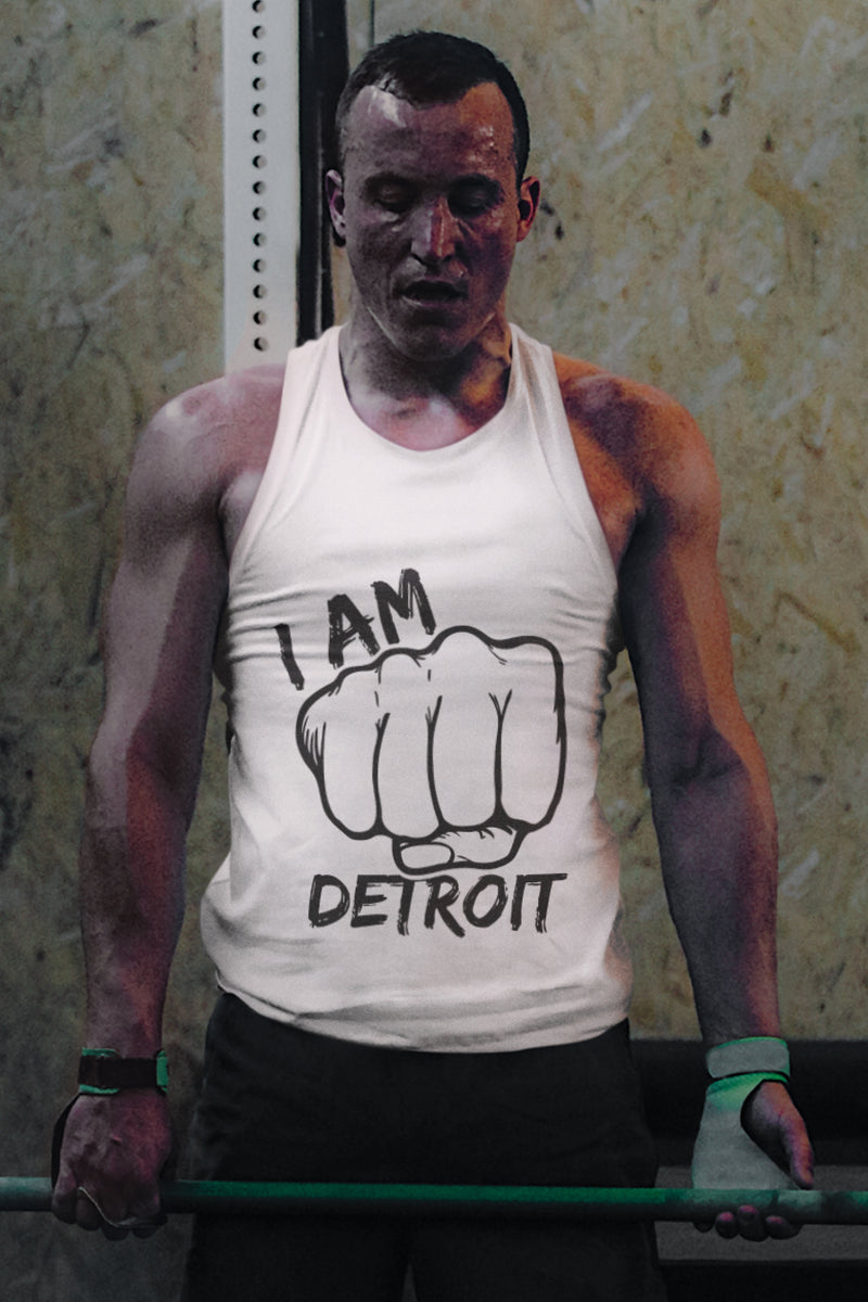 Weightlifter holding barbell wearing a white tank top with black I Am Detroit Fist logo printed across the front