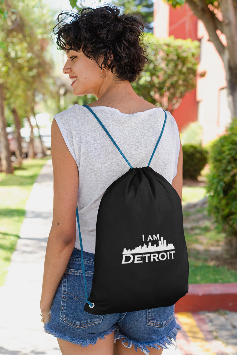 Easy going women walking down a side walk on a sunny day feeling great about her I Am Detroit Apparel knapsack 