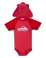 Adorable cozy red colored onsie with small white I Am Detroit logo printed across the front 