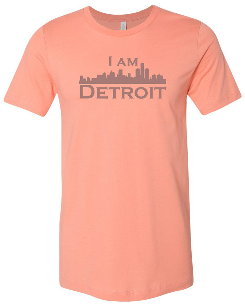 Sunset colored short sleeve t-shirt with large gray I Am Detroit logo printed across the chest