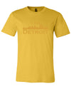 Maize colored short sleeve t-shirt with large maize I Am Detroit logo printed across the chest