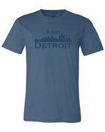 Steel navy colored short sleeve t-shirt with large steel navy colored I Am Detroit logo printed across the chest