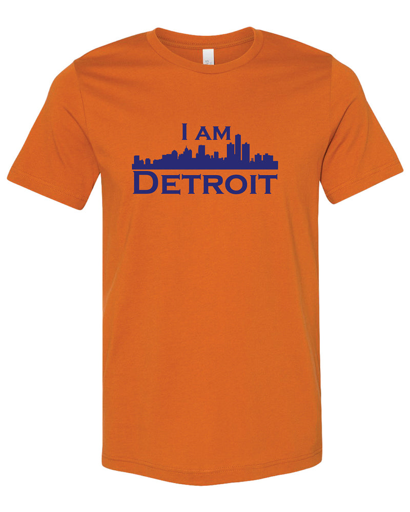 Orange colored short sleeve t-shirt with large dark blue I Am Detroit logo printed across the chest